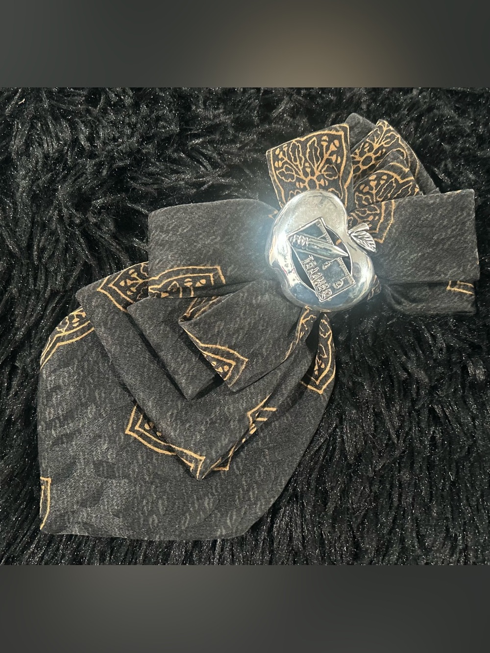 Black Brooch Tie with Gold Print and Silver Apple Teacher Brooch Accent